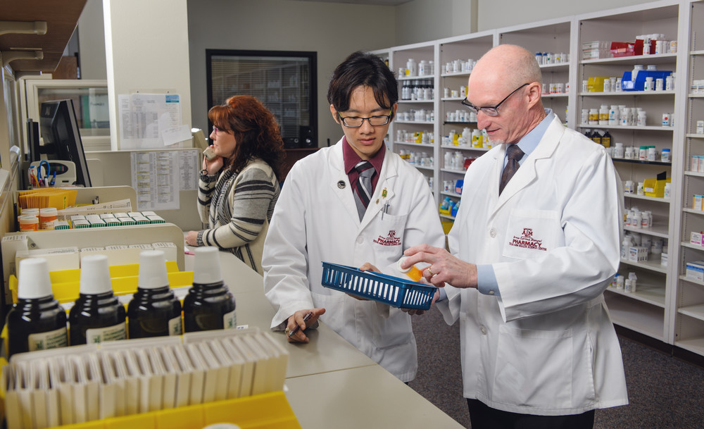 School of Pharmacy Student learns with a technician