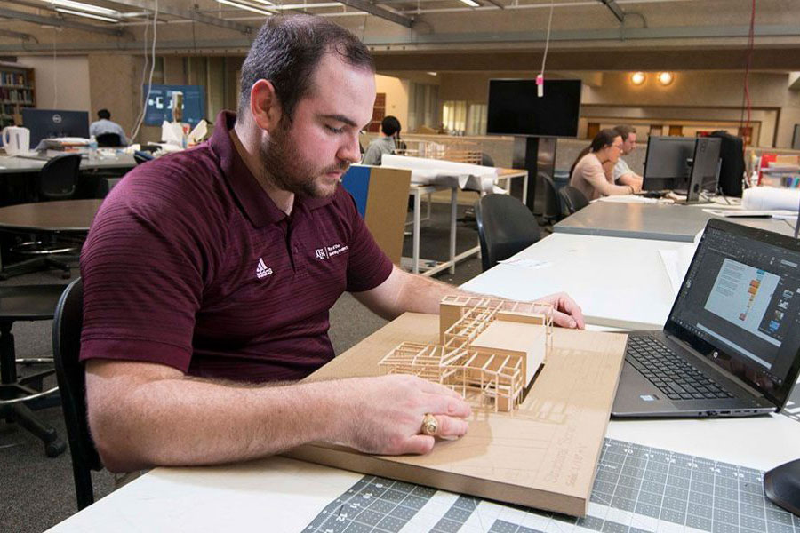 Architecture student builds a small-scale model building out of wood.